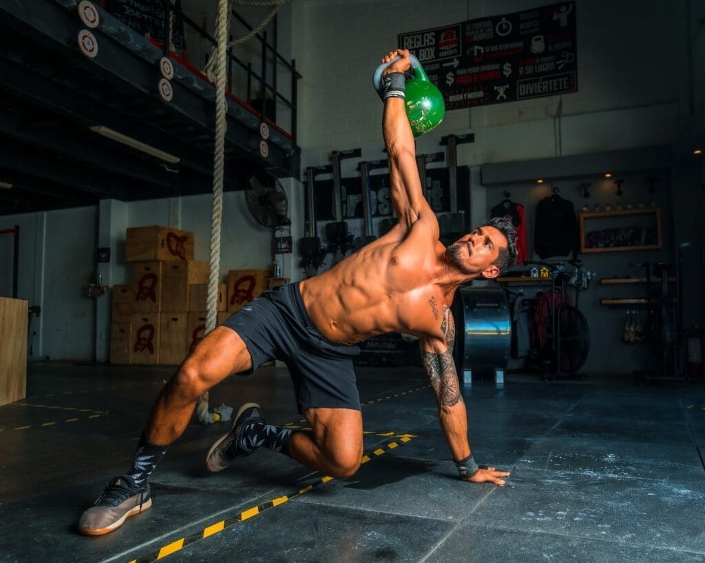 Men's Health Week 2023: man in black shorts and black tank top doing push up