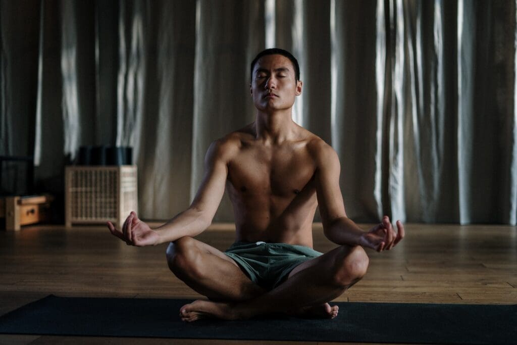 Men's Health Week 2023: Fitness & Nutrition: Topless Man in Blue Denim Shorts Sitting on Floor