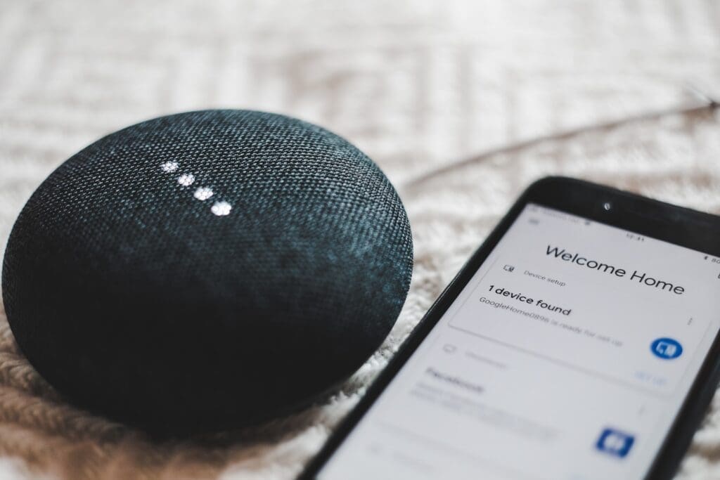 Streaming Audio Trends. turned-on charcoal Google Home Mini and smartphone